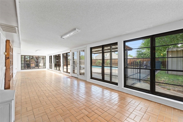 2801 Good Shepherd Dr, Brownwood, TX 76801 - spare room featuring a textured ceiling and brick patterned flooring
