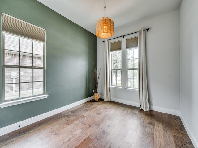 7621 Newtown, The Colony, TX 75056 - empty room with wood finished floors and baseboards