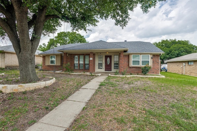1321 Glyndon Dr, Plano, TX 75023 - view of front of house with brick siding, a front lawn, and roof with shingles