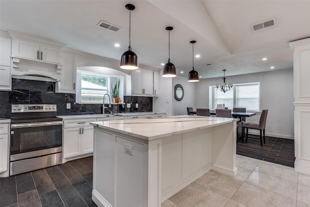 1321 Glyndon Dr, Plano, TX 75023 - kitchen featuring stainless steel electric range oven, a sink, premium range hood, a kitchen island, and decorative backsplash