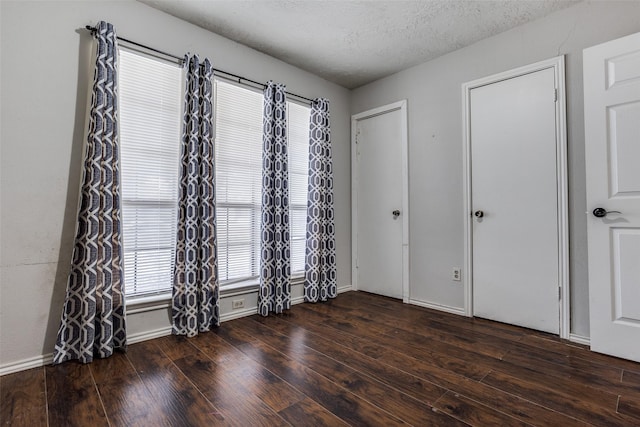 1321 Glyndon Dr, Plano, TX 75023 - unfurnished bedroom with wood finished floors, a textured ceiling, and baseboards