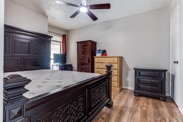 1321 Glyndon Dr, Plano, TX 75023 - bedroom with a textured ceiling, wood finished floors, baseboards, and ceiling fan