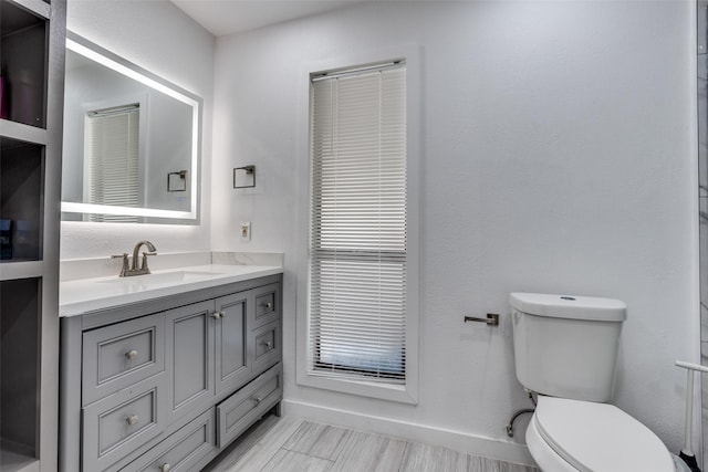 1321 Glyndon Dr, Plano, TX 75023 - bathroom featuring toilet, vanity, and baseboards