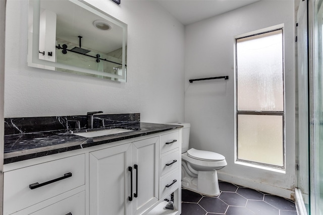 1321 Glyndon Dr, Plano, TX 75023 - bathroom with plenty of natural light, vanity, toilet, and walk in shower
