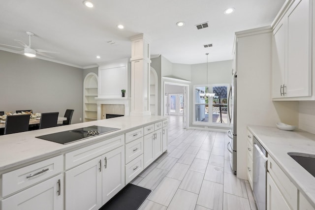 4616 Heatherbrook Ln, Grand Prairie, TX 75052 - kitchen with stainless steel appliances, white cabinets, ceiling fan, a chandelier, and recessed lighting