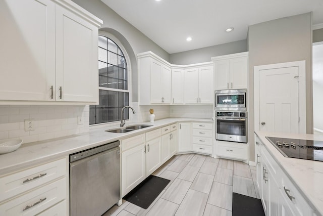 4616 Heatherbrook Ln, Grand Prairie, TX 75052 - kitchen with appliances with stainless steel finishes, a sink, tasteful backsplash, white cabinets, and recessed lighting