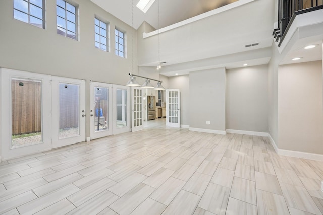 4616 Heatherbrook Ln, Grand Prairie, TX 75052 - empty room with a towering ceiling, french doors, and baseboards