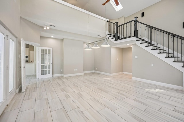 4616 Heatherbrook Ln, Grand Prairie, TX 75052 - unfurnished living room with stairs, french doors, a skylight, ceiling fan, and baseboards