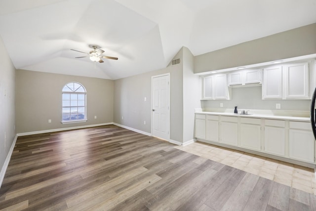 4616 Heatherbrook Ln, Grand Prairie, TX 75052 - kitchen featuring ceiling fan, lofted ceiling, light wood-type flooring, light countertops, and baseboards