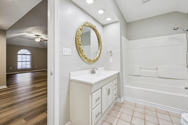 4616 Heatherbrook Ln, Grand Prairie, TX 75052 - bathroom with vanity, tub / shower combination, vaulted ceiling, ceiling fan, and wood finished floors