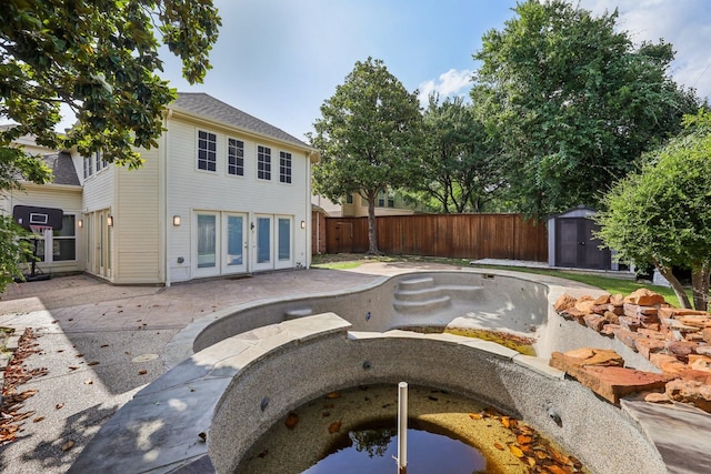 4616 Heatherbrook Ln, Grand Prairie, TX 75052 - back of property with a fenced backyard, a patio, and french doors