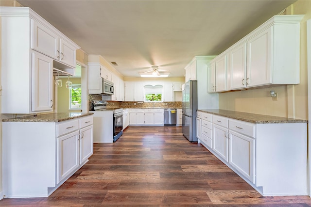 522 E Kempner St, Mabank, TX 75147 - kitchen with stainless steel appliances, white cabinets, and dark wood finished floors