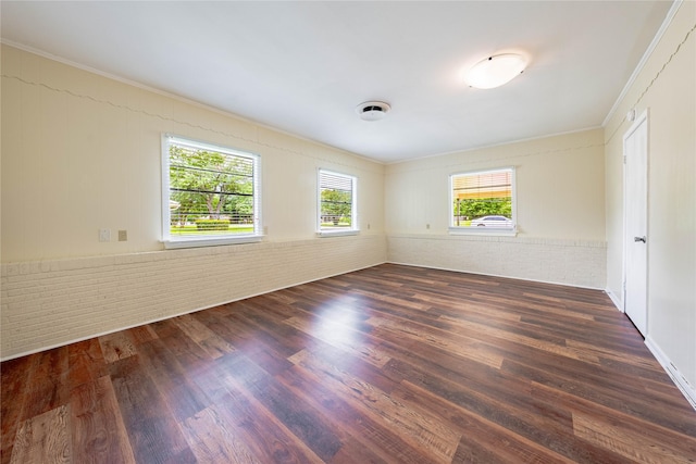 522 E Kempner St, Mabank, TX 75147 - spare room with ornamental molding, wood finished floors, and brick wall