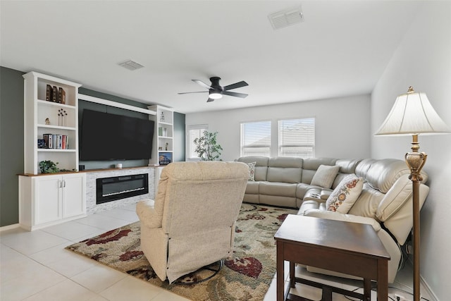 8329 Grand Oak Rd, Fort Worth, TX 76123 - living room featuring ceiling fan, a glass covered fireplace, and light tile patterned floors