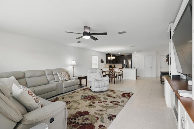 8329 Grand Oak Rd, Fort Worth, TX 76123 - living room with ceiling fan, light tile patterned floors, and a chandelier