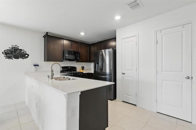 8329 Grand Oak Rd, Fort Worth, TX 76123 - kitchen with black appliances, light tile patterned floors, dark brown cabinetry, a peninsula, and light countertops