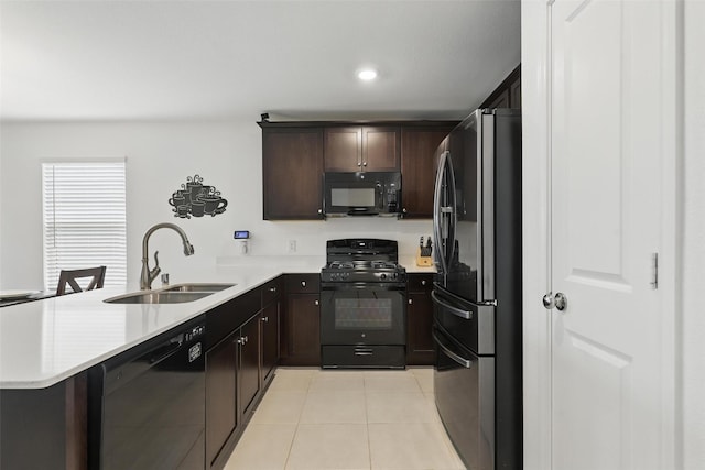 8329 Grand Oak Rd, Fort Worth, TX 76123 - kitchen with black appliances, a sink, a peninsula, light tile patterned floors, and dark brown cabinetry