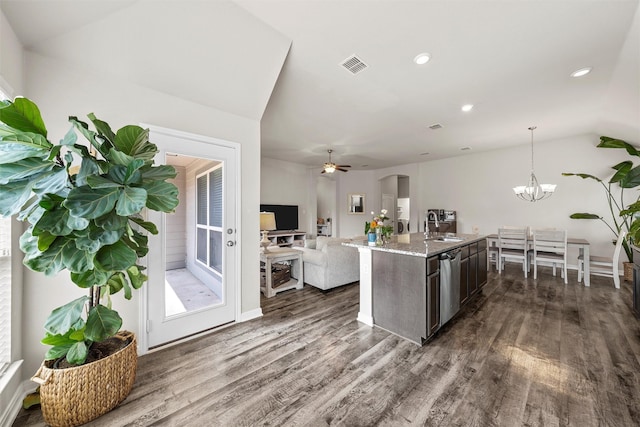 3009 Gilchrist Dr, Lorena, TX 76655 - kitchen with dark wood finished floors, lofted ceiling, a sink, light stone countertops, and open floor plan