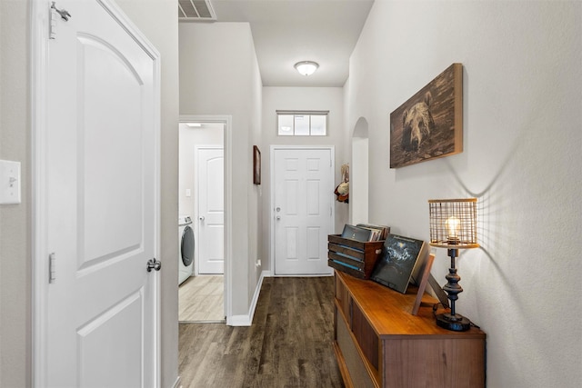 3009 Gilchrist Dr, Lorena, TX 76655 - entryway featuring arched walkways, dark wood-style floors, and baseboards