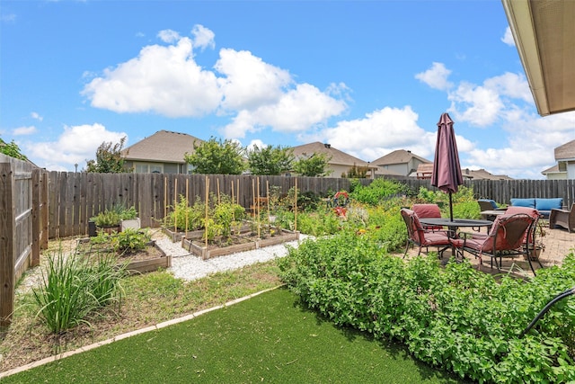 3009 Gilchrist Dr, Lorena, TX 76655 - fenced backyard with a vegetable garden, an outdoor hangout area, and a patio