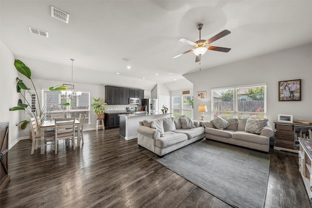 3009 Gilchrist Dr, Lorena, TX 76655 - living room with vaulted ceiling, a ceiling fan, dark wood-type flooring, a chandelier, and baseboards