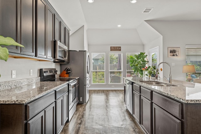 3009 Gilchrist Dr, Lorena, TX 76655 - kitchen featuring stainless steel appliances, a sink, dark wood-style flooring, dark brown cabinets, and lofted ceiling