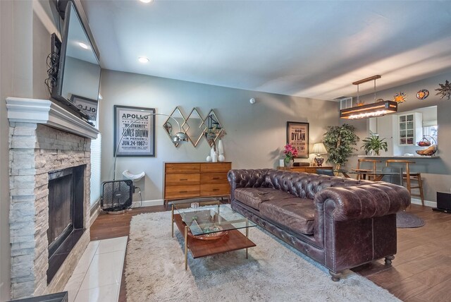 5701 Gaston Ave Unit 8, Dallas, TX 75214 - living area with a stone fireplace, wood finished floors, recessed lighting, and baseboards