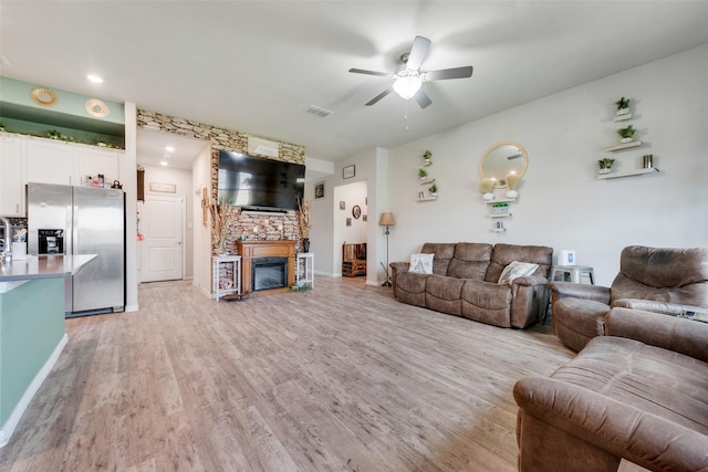 621 Hidden Cove Dr, Princeton, TX 75407 - living area featuring ceiling fan, light wood-style flooring, a fireplace, and baseboards