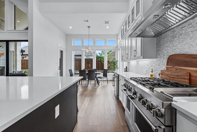 1733 Cousins Trl, Frisco, TX 75034 - kitchen with range with two ovens, custom exhaust hood, light countertops, white cabinets, and recessed lighting