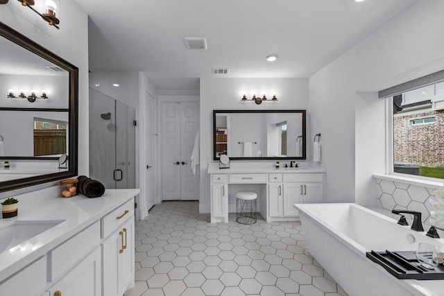 1733 Cousins Trl, Frisco, TX 75034 - full bathroom featuring a shower stall, a soaking tub, two vanities, tile patterned flooring, and recessed lighting