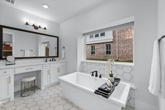 1733 Cousins Trl, Frisco, TX 75034 - bathroom featuring a soaking tub, vanity, and tile patterned floors