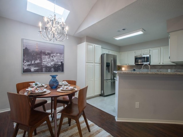 2800 Country Villa Cir, Carrollton, TX 75006 - dining area featuring a skylight, wood finished floors, a chandelier, lofted ceiling, and baseboards