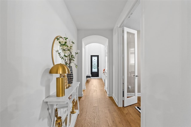 1431 Cypress Thorn Dr, Arlington, TX 76005 - hall with arched walkways, light wood-style floors, and baseboards