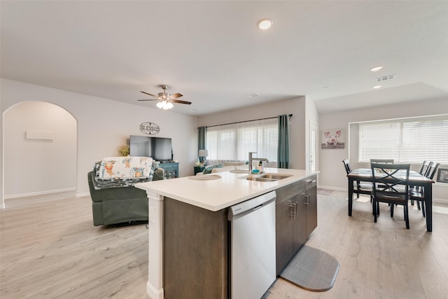 3615 Big Nemaha Dr, Crandall, TX 75114 - kitchen with stainless steel dishwasher, a sink, a kitchen island with sink, arched walkways, and open floor plan