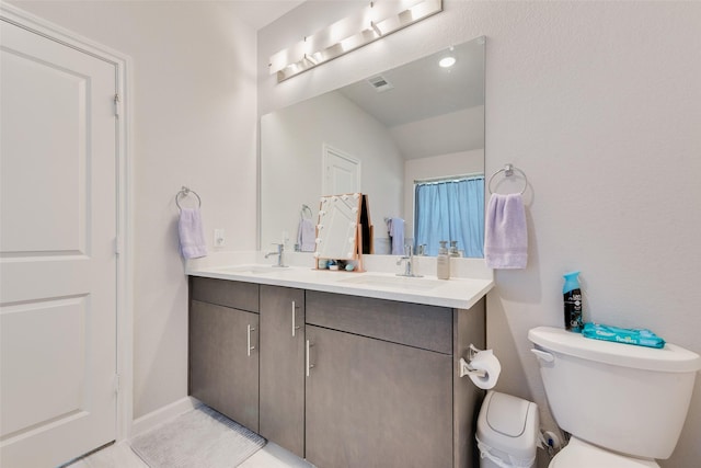 3615 Big Nemaha Dr, Crandall, TX 75114 - bathroom featuring double vanity, toilet, and vaulted ceiling