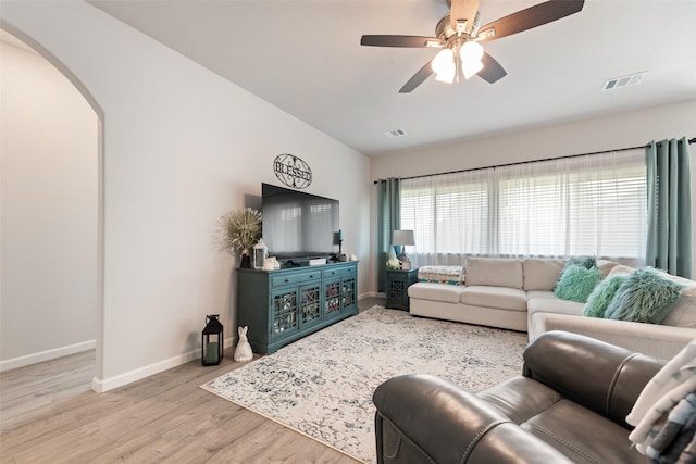 3615 Big Nemaha Dr, Crandall, TX 75114 - living area with arched walkways, baseboards, wood finished floors, and ceiling fan