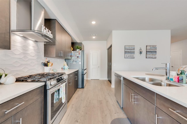 3615 Big Nemaha Dr, Crandall, TX 75114 - kitchen with wall chimney exhaust hood, appliances with stainless steel finishes, a sink, light countertops, and light wood finished floors
