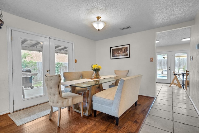 818 Placid Dr, Mesquite, TX 75150 - dining area with french doors, a textured ceiling, baseboards, and wood finished floors