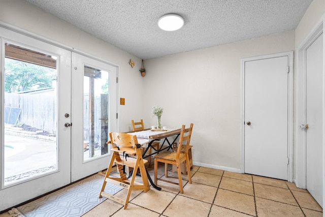 818 Placid Dr, Mesquite, TX 75150 - dining space featuring french doors and a textured ceiling