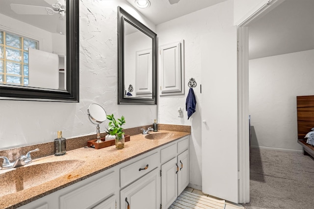 818 Placid Dr, Mesquite, TX 75150 - bathroom featuring double vanity, ceiling fan, connected bathroom, and tile patterned floors