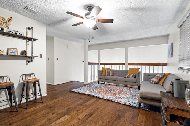 818 Placid Dr, Mesquite, TX 75150 - living room featuring a ceiling fan, a textured ceiling, wood finished floors, and baseboards