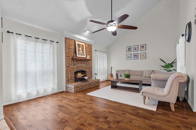 818 Placid Dr, Mesquite, TX 75150 - living room featuring ceiling fan, healthy amount of natural light, wood finished floors, a fireplace, and high vaulted ceiling
