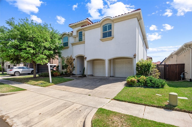 2504 Las Palmas Ln, Plano, TX 75075 - mediterranean / spanish-style house with a garage, concrete driveway, a tiled roof, and stucco siding