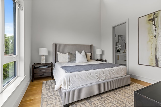 3909 Hawthorne Ave Unit 101, Dallas, TX 75219 - bedroom featuring light wood-style floors