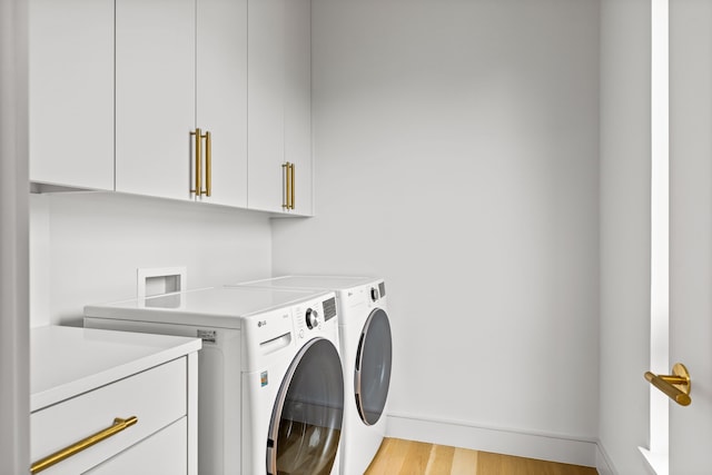 3909 Hawthorne Ave Unit 101, Dallas, TX 75219 - laundry area with cabinet space, separate washer and dryer, baseboards, and light wood-style floors