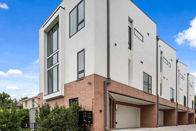 3909 Hawthorne Ave Unit 101, Dallas, TX 75219 - view of property with an attached garage and driveway