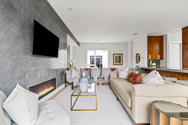 3909 Hawthorne Ave Unit 101, Dallas, TX 75219 - living room featuring a premium fireplace