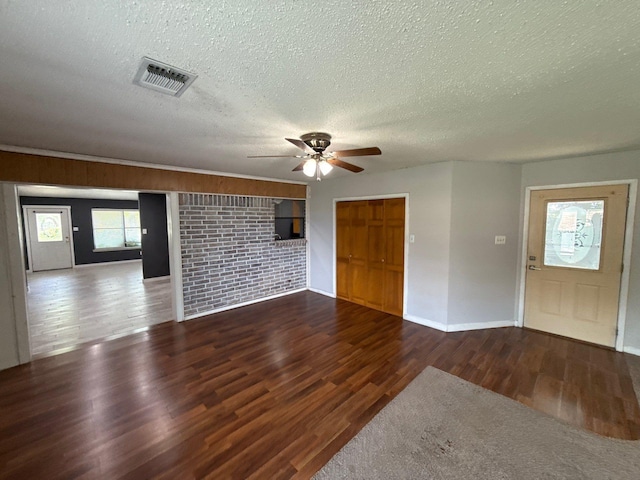 137 W 6th St, Krum, TX 76249 - unfurnished living room with a textured ceiling, ceiling fan, wood finished floors, and baseboards