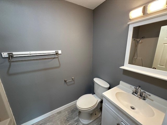137 W 6th St, Krum, TX 76249 - full bathroom with toilet, vanity, a shower, baseboards, and wood finished floors