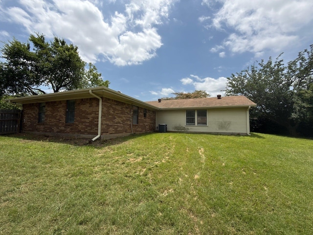 137 W 6th St, Krum, TX 76249 - rear view of property featuring central AC unit and brick siding
